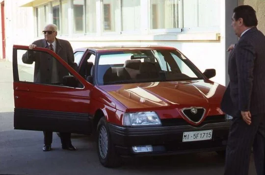 Enzo Ferrari accanto alla sua Alfa 164 rossa, targa MI-5F1715